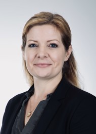 Headshot of a caucasian woman with auburn hair