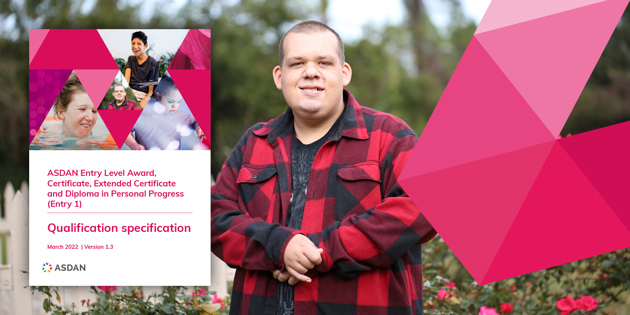 Young man in a red tartan shirt smiling at the camera with the cover of an ASDAN Personal Progress Qualification Specification to the left